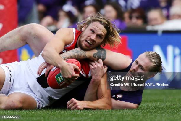 Sam Gilbert of the Saints is tackled by Cam McCarthy of the Dockers during the round 15 AFL match between the Fremantle Dockers and the St Kilda...