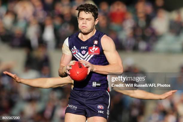 Lachie Neale of the Dockers marks the ball during the round 15 AFL match between the Fremantle Dockers and the St Kilda Saints at Domain Stadium on...