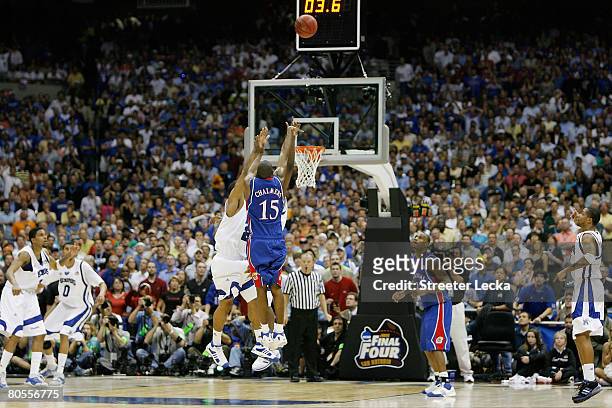 Mario Chalmers of the Kansas Jayhawks shoots and makes a three-pointer to tie the game to send it into overtime against the Memphis Tigers during the...