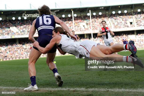 David Mundy of the Dockers is tackled by Jack Steele of the Saints during the round 15 AFL match between the Fremantle Dockers and the St Kilda...