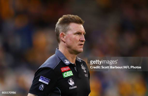 Nathan Buckley, coach of the Magpies speaks to his team during a quarter time break during the round 15 AFL match between the Hawthorn Hawks and the...