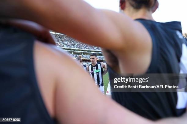 Scott Pendlebury of the Magpies speaks to his team in a huddle during the round 15 AFL match between the Hawthorn Hawks and the Collingwood Magpies...