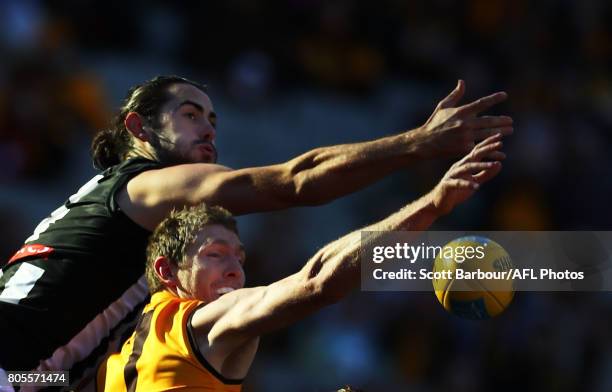 Ben McEvoy of the Hawks and Brodie Grundy of the Magpies compete for the ball during the round 15 AFL match between the Hawthorn Hawks and the...