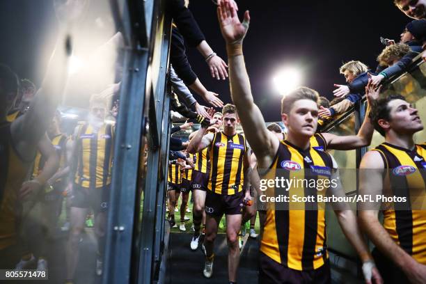 The Hawks walk down the players race as they celebrate with supporters in the crowd after winning round 15 AFL match between the Hawthorn Hawks and...