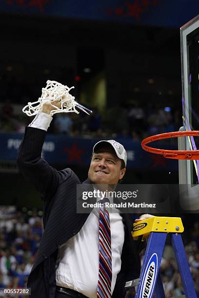 Head coach Bill Self of the Kansas Jayhawks celebrates by cutting down the nets after defeating the Memphis Tigers 75-68 in overtime during the 2008...