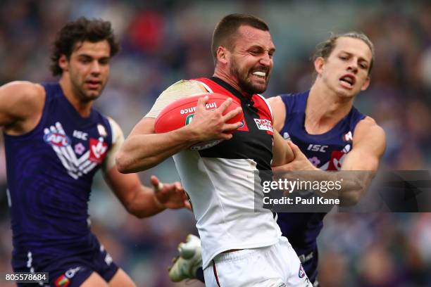 Jarryn Geary of the Saints attampts to break from a atckle by Nathan Fyfe of the Dockers during the round 15 AFL match between the Fremantle Dockers...
