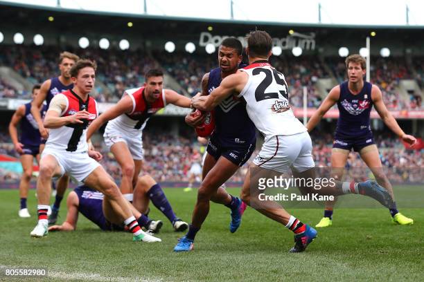 Bradley Hill of the Dockers gets tackled by Koby Stevens of the Saints during the round 15 AFL match between the Fremantle Dockers and the St Kilda...