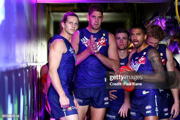 Nathan Fyfe, Aaron Sandilands and Bradley Hill of the Dockers wait to run out onto the field during the round 15 AFL match between the Fremantle...