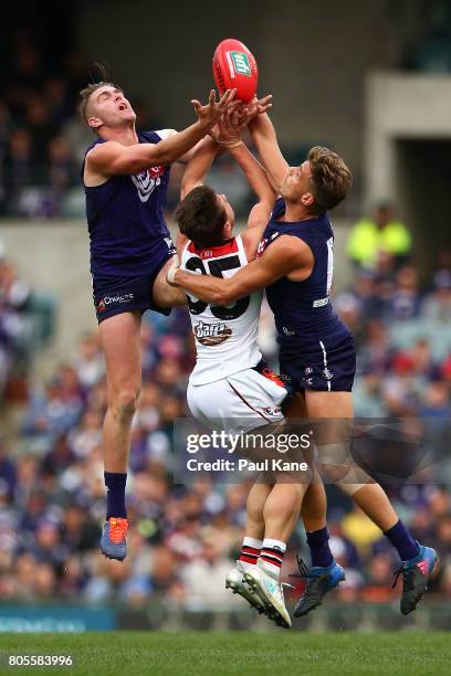 Luke Ryan and Tommy Sheridan of the Dockers contest a mark against Jack Sinclair of the Saints during the round 15 AFL match between the Fremantle...