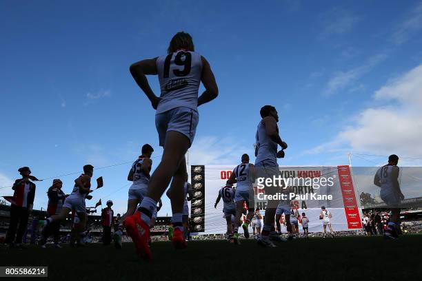 The Saints run onto the field during the round 15 AFL match between the Fremantle Dockers and the St Kilda Saints at Domain Stadium on July 2, 2017...