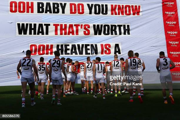 The Saints run thru their banner during the round 15 AFL match between the Fremantle Dockers and the St Kilda Saints at Domain Stadium on July 2,...