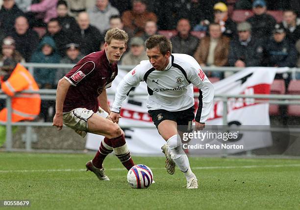 Darren Currie of Luton Town looks to play the ball watched by Daniel Jones of Northampton Town during the Coca Cola League One Match between...