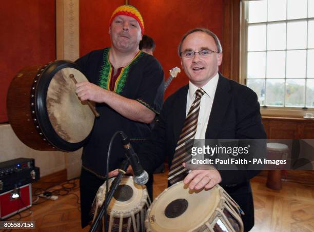 Committee for Culture, Arts and Leisure Chairperson Barry McElduff MLA tries his hand at drumming in the Long Gallery, Stormont in Northern Ireland.