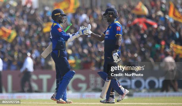 Sri Lankan cricket captain Angelo Mathews and Upul Tharanga congratulate each other after securing the victory during the 2nd One Day International...