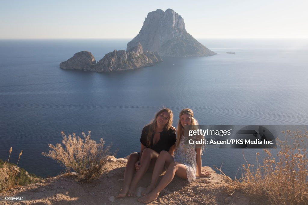 Young women relax in coastal landscape