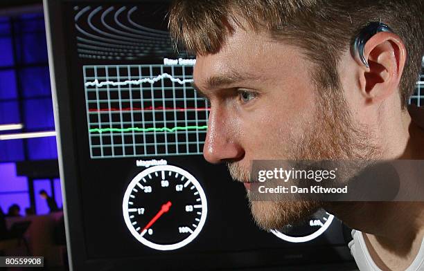 Julien Pansiot of Imperial College London demonstrates the use of a wireless ear sensor used in congunction with a treadmill and a computer, at The...