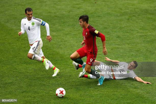 Andres Guardado of Mexico tackles Andre Silva of Portugal during the FIFA Confederations Cup Russia 2017 Play-Off for Third Place between Portugal...