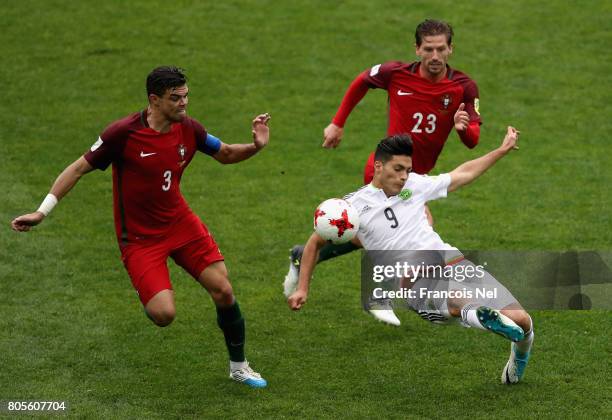 Raul Jimenez of Mexico clears the ball while under pressure from Pepe of Portugal during the FIFA Confederations Cup Russia 2017 Play-Off for Third...