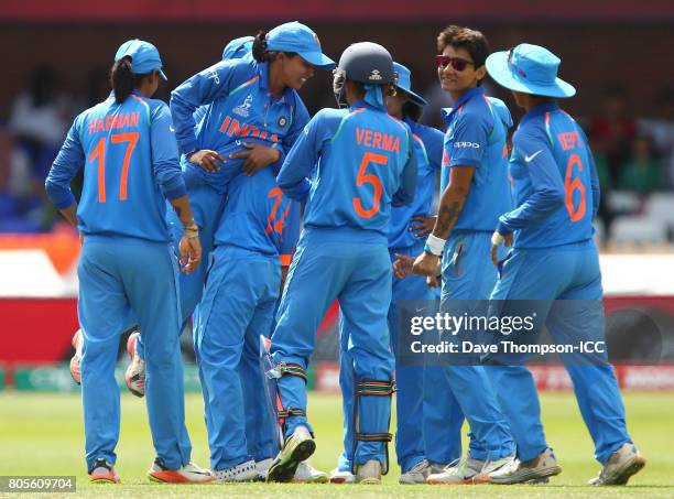 Ekta Bisht of India is lifted off the ground by team mates after taking the wiglet of Sidra Nawaz of Pakistan during the ICC Women's World Cup match...