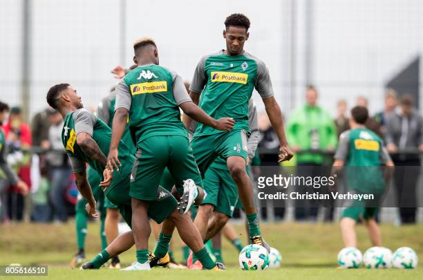 Kwame Yeboah, Ba-Muaka Simakala and Reece Oxford battle for the ball during a training session of Borussia Moenchengladbach at Borussia-Park on July...