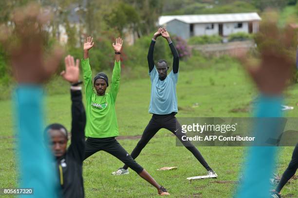 James Nyang Chiengjiek , a South Sudanese refugee and 400m Olympian at the Rio Olympic Games stretches alongside fellow refugees on May 12, 2017...