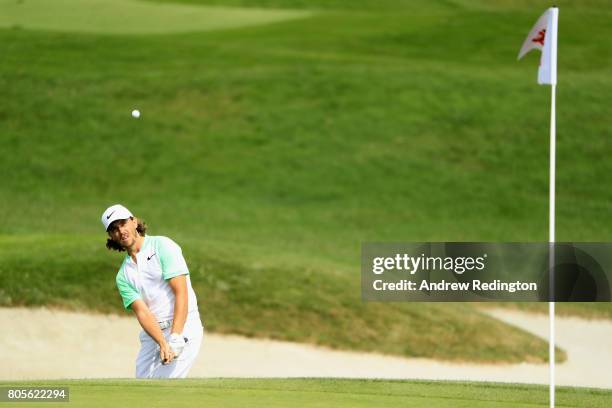 Tommy Fleetwood of England plays his third shot out of the bunker on the 14th during day four of the HNA Open de France at Le Golf National on July...