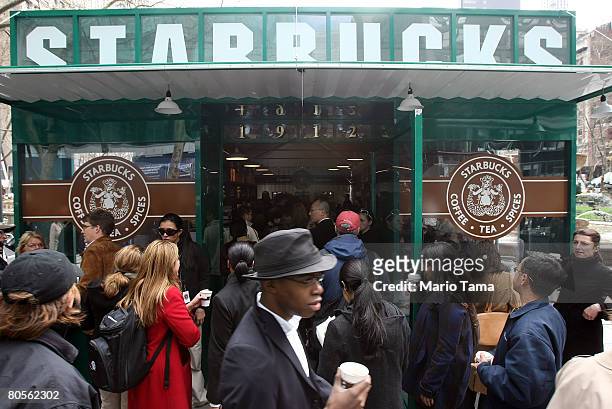 People gather as free samples of Starbucks' new "everyday" brew Pikes Place Roast are handed out in Bryant Park April 8, 2008 in New York City....