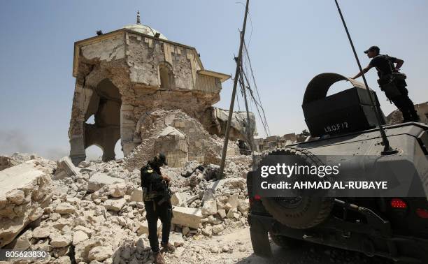 Members of the Iraqi Counter-Terrorism Service gather outside the destroyed Al-Nuri Mosque in the Old City of Mosul on July 2 during the Iraqi...