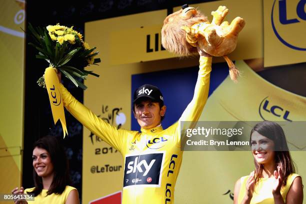 Race leader Geraint Thomas of Great Britain and Team Sky celebrates with the yellow leaders jersey on the podium during stage two of the 2017 Tour de...