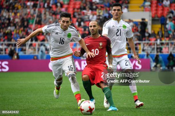 Mexico's midfielder Hector Herrera and Mexico's defender Luis Reyes vies with Portugal's forward Ricardo Quaresma during the 2017 Confederations Cup...