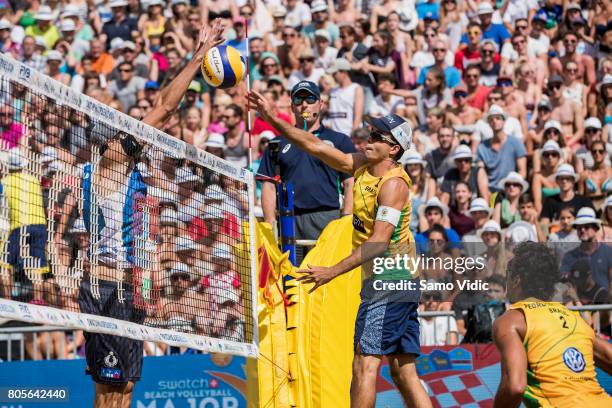 Pedro Solberg Salgado of Brazil spikes the ball during the gold medal match against Daniele Lupo and Paolo Nicolai of Italy during the second stage...