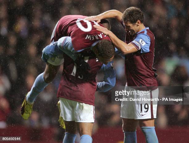 Aston Villa's John Carew celebrates with team mates Gabriel Agbonlahor and Stiliyan Petrov after scoring from the penalty spot.