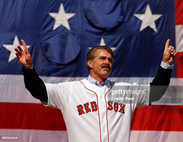 Former Boston Red Sox player Bill Buckner acknowledges the cheers from the crowd before throwing out the ceremonial first pitch at the MLB baseball...