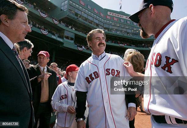 Former Boston Red Sox player Bill Buckner is received by Red Sox's Kevin Youkilis and Red Sox Chairman and co-owner Tom Werner during season home...