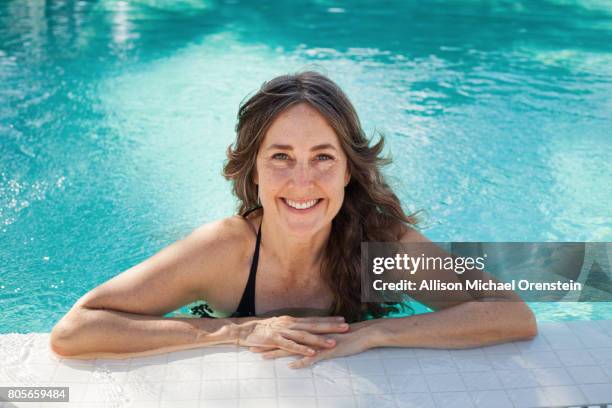 woman in the pool smiling - older woman bathing suit stock pictures, royalty-free photos & images