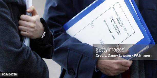 Chairman Sir Philip Hampton holds an RBS briefing pack as he arrives at a Royal Bank of Scotland Conference Centre base at RBS in Gogarburn near...