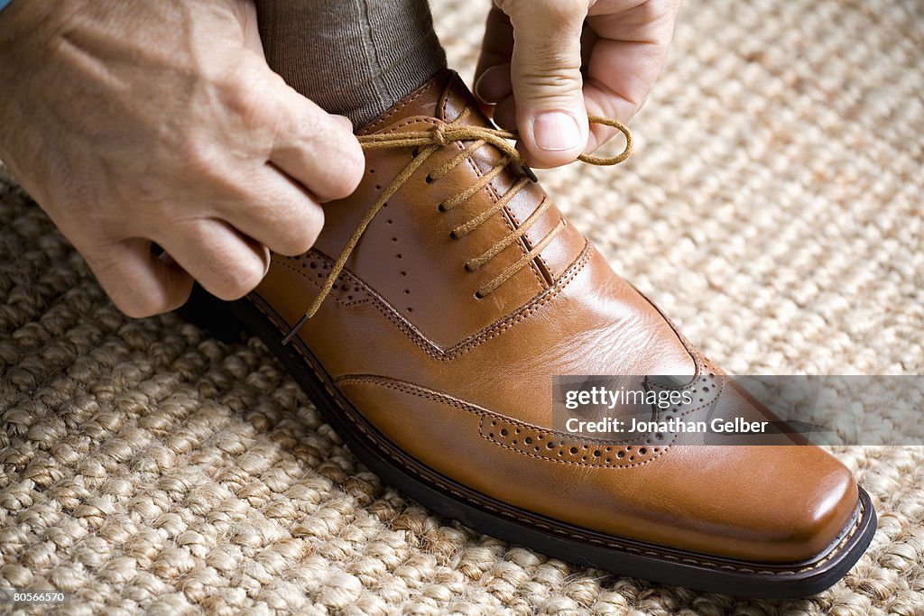 Close up of hands tying shoelace