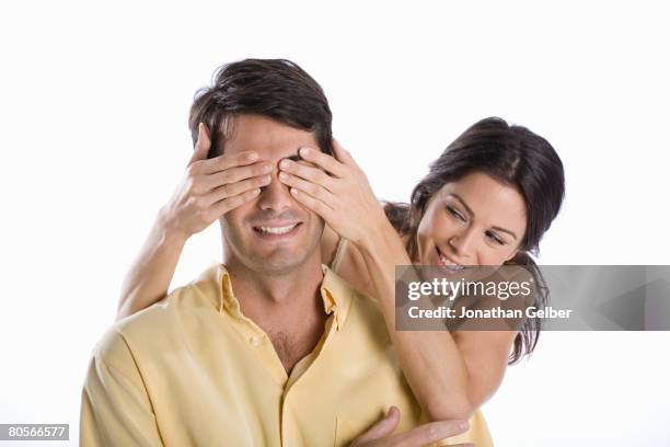 a woman covering a man's eyes - man hands covering eyes stock pictures, royalty-free photos & images