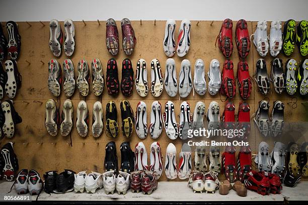 football boots hanging on a wall - soccer boot stock pictures, royalty-free photos & images