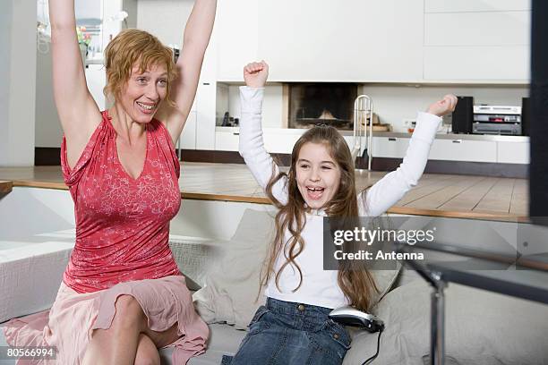 a mother and daughter celebrating - remote control antenna stock pictures, royalty-free photos & images