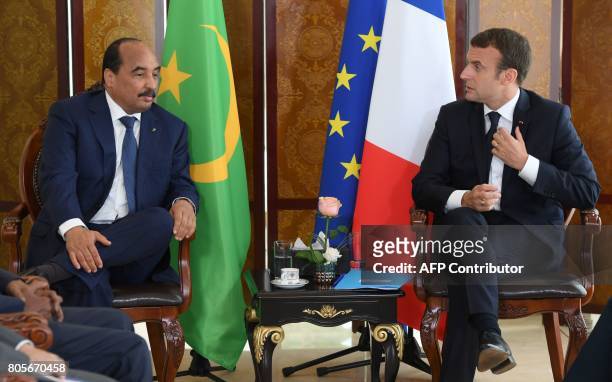 French President Emmanuel Macron talks with Mauritanian President Mohamed Ould Abdel Aziz during a G5 Sahel summit, in Bamako, on July 2 to boost...