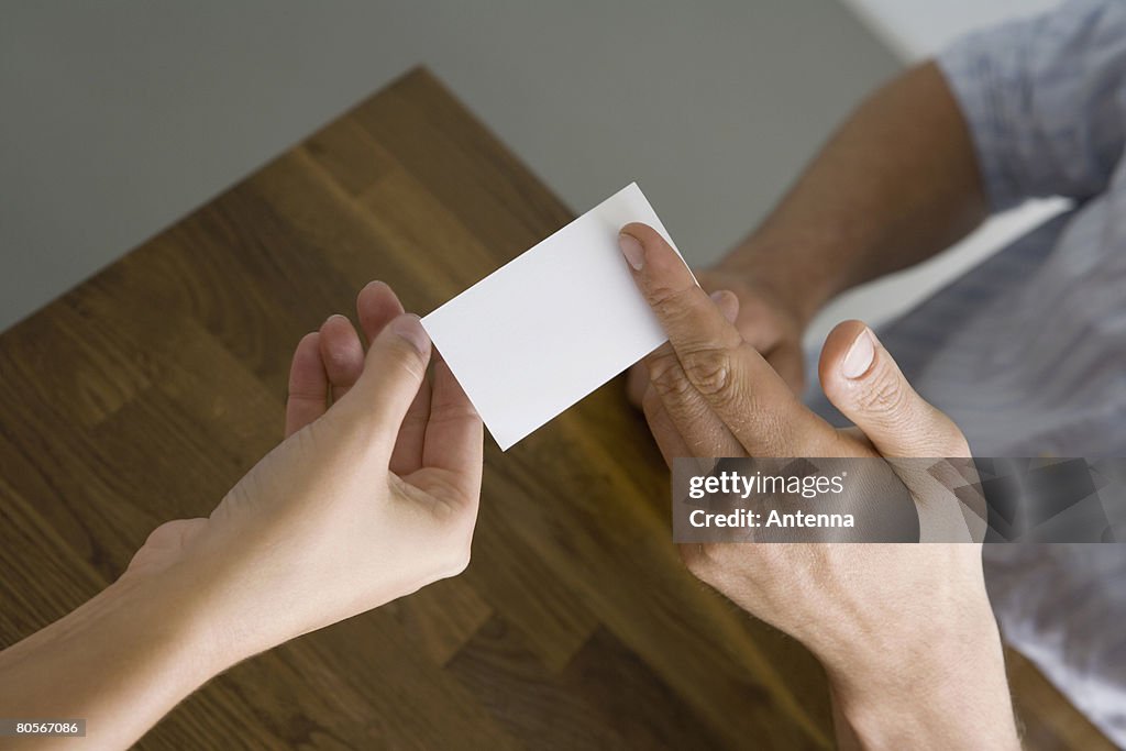 A man and a woman exchanging a business card