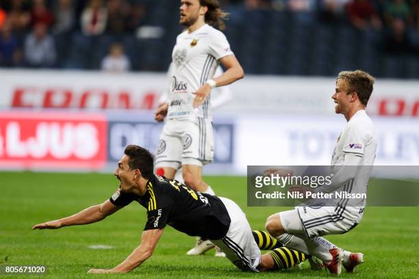 Stefan Ishizaki of AIK is tackled by Dennis Widgren of Ostersunds FK during the Allsvenskan match between AIK and Ostersunds FK at Friends arena on...
