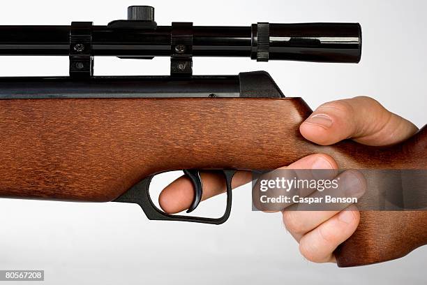 a hand holding a gun - trigger stock pictures, royalty-free photos & images