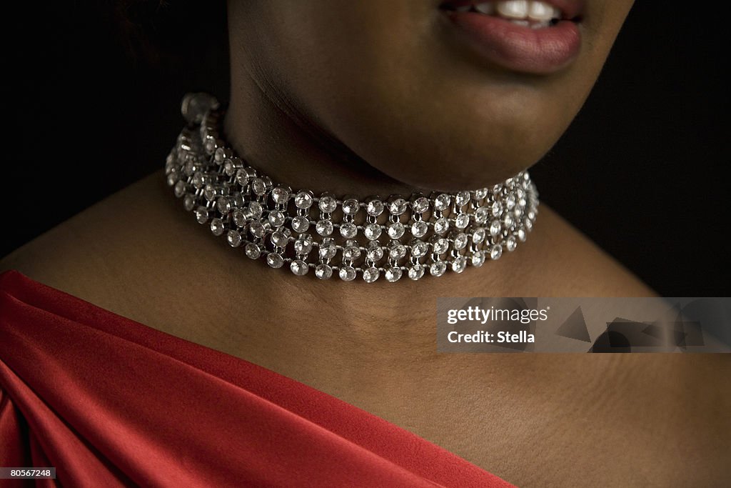 A woman wearing a diamond necklace