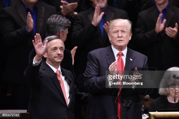 President Donald Trump, right, applauds as pastor Robert Jeffress waves during the "Celebrate Freedom" event at the John F. Kennedy Center for the...