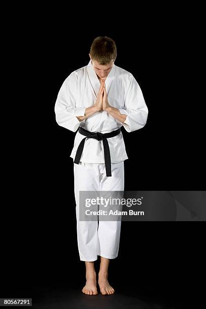 a young man wearing a karate suit - adam bow stockfoto's en -beelden