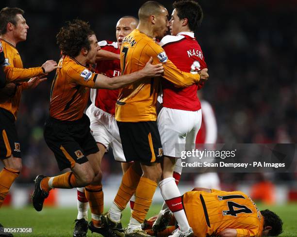 Arsenal's Samir Nasri is surrounded by Hull City players after striking out at Hull City's Richard Garcia