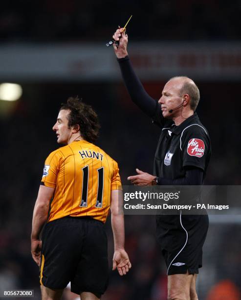 Hull City's Stephen Hunt is shown a yellow card by referee Steve Bennett for his part in a brawl between the two sets of players after Arsenal's...