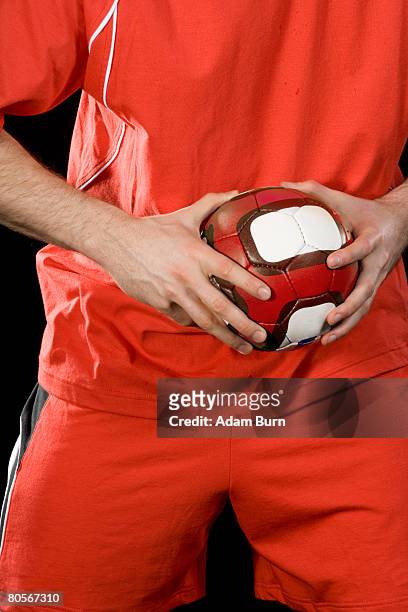 a man playing handball - handbal stockfoto's en -beelden